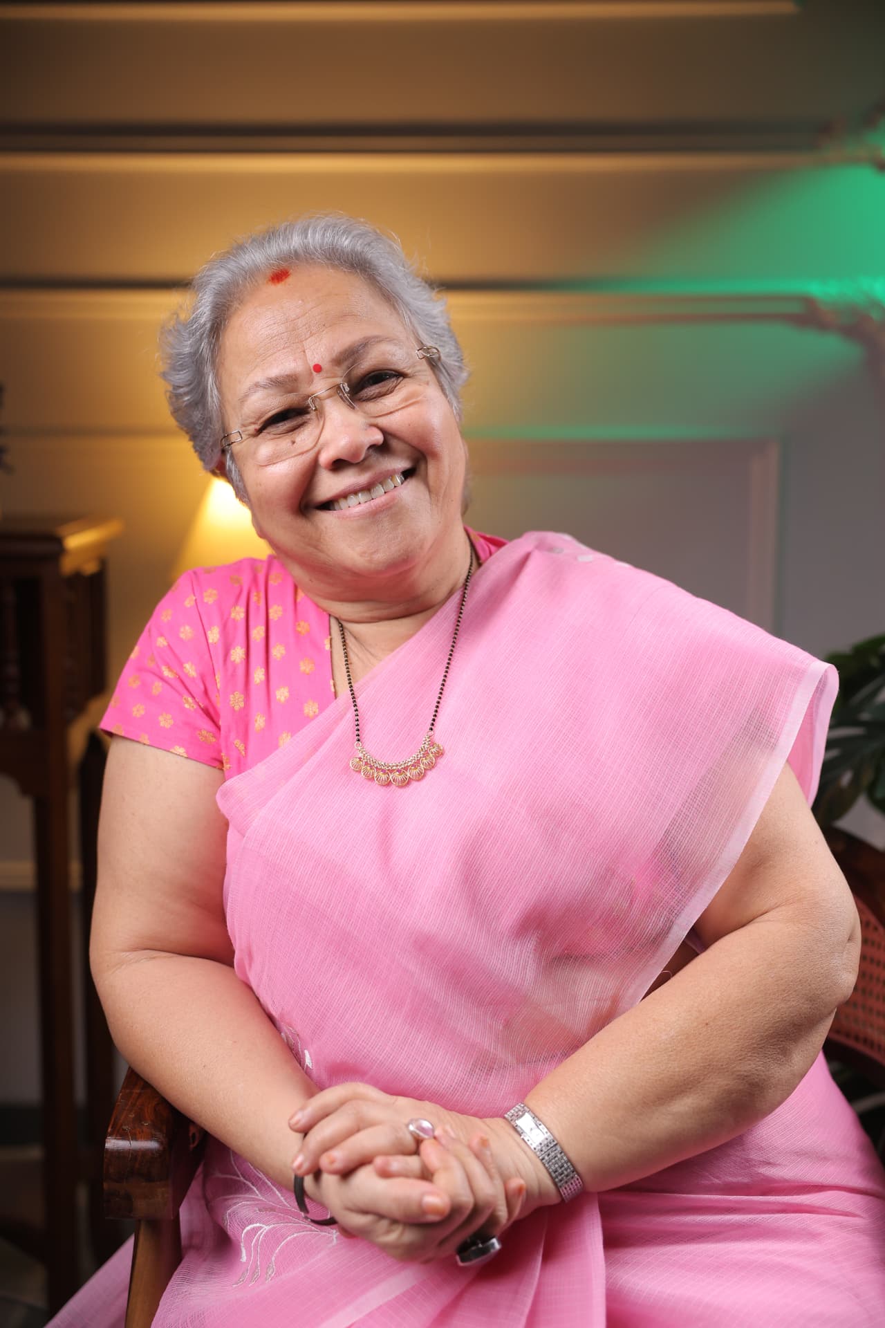 Sharda Karve smiling in a pink sari