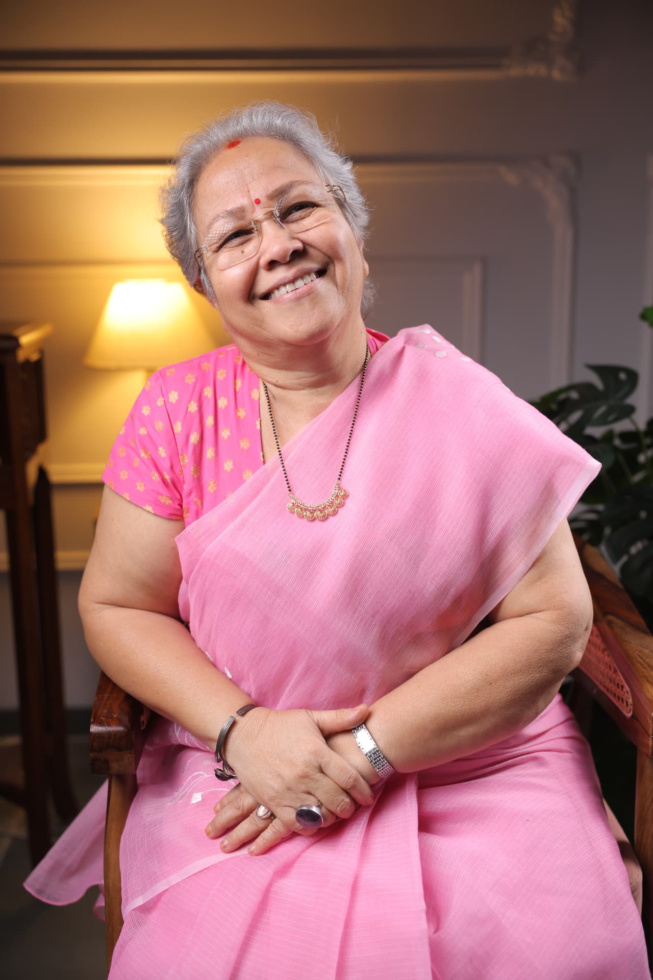 Sharda Karve smiling in a pink sari